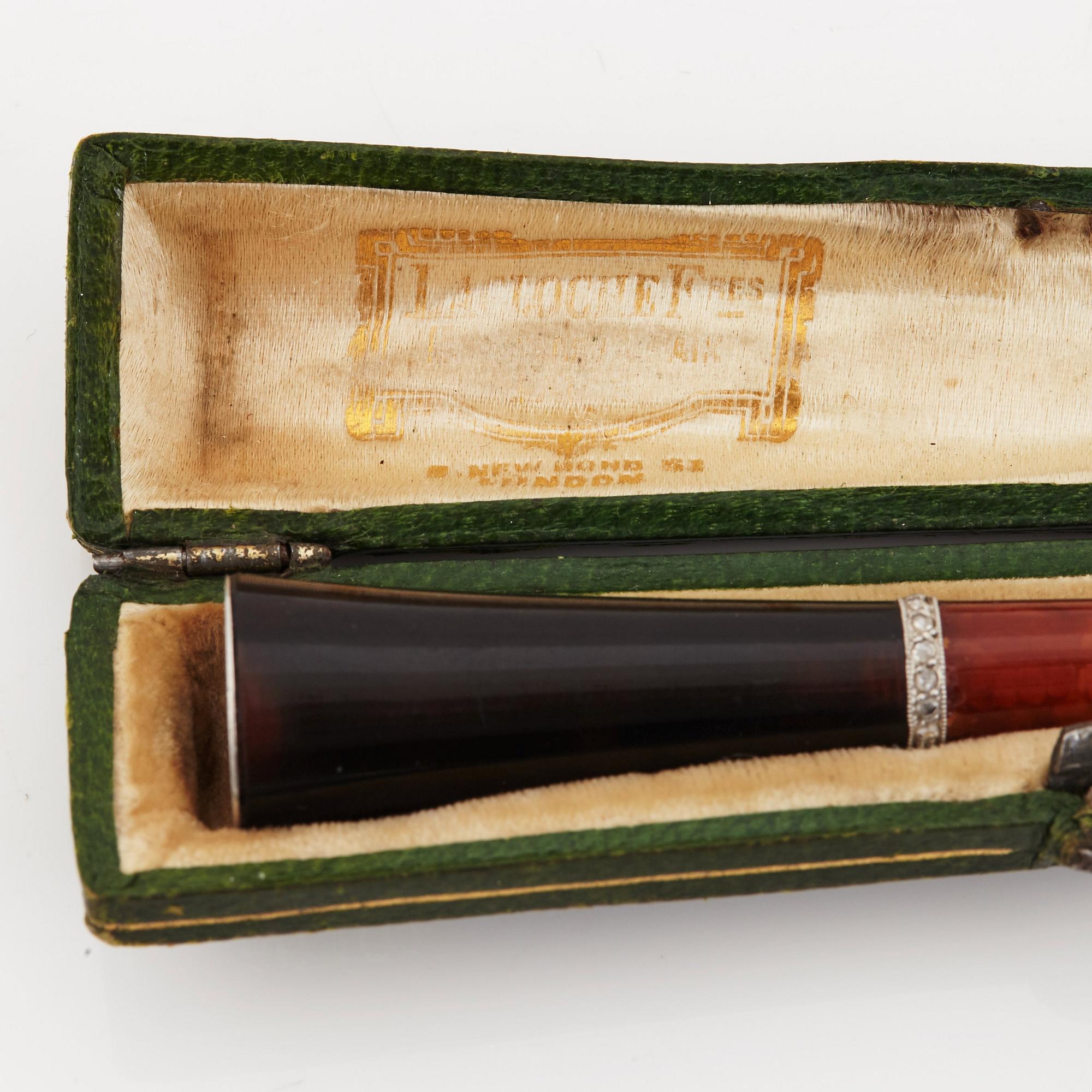A 1920's cigarette holder of tortoiseshell and meerschaum decorated with rose-cut diamonds.