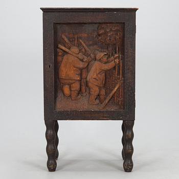 A 1920s cabinet with a relief.