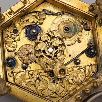 A gilded brass baroque travel clock from around 1700, with original case.
