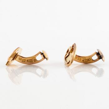 A pair of 14K gold cufflinks set with old-cut diamonds.