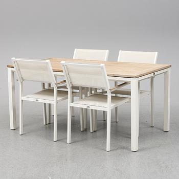 A garden table with four chairs, Gloster.