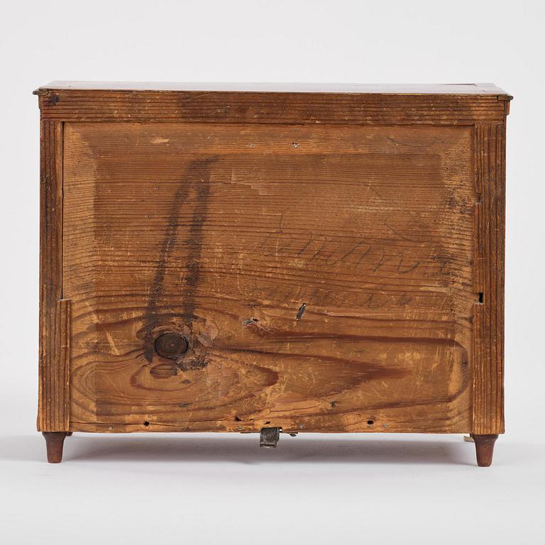 A Northern European mahogany miniature commode, early 19th century.