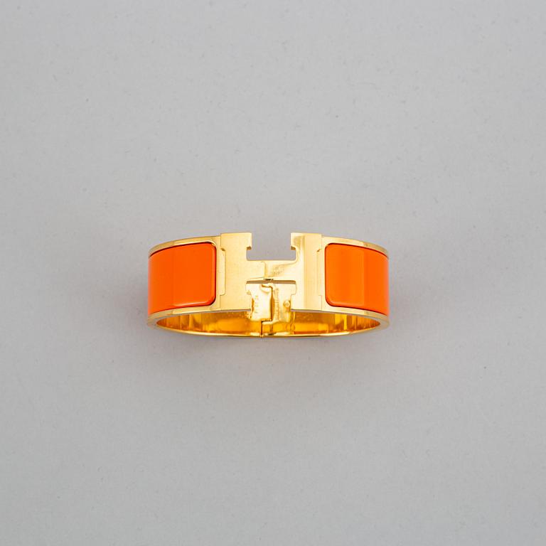HERMÈS, a 'Clic H' bangle.