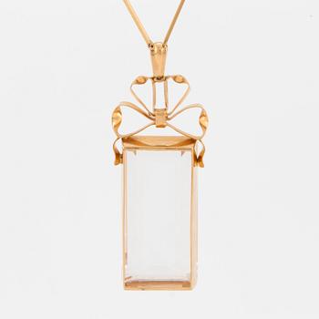 A chain and a pendant set with step-cut quartz.