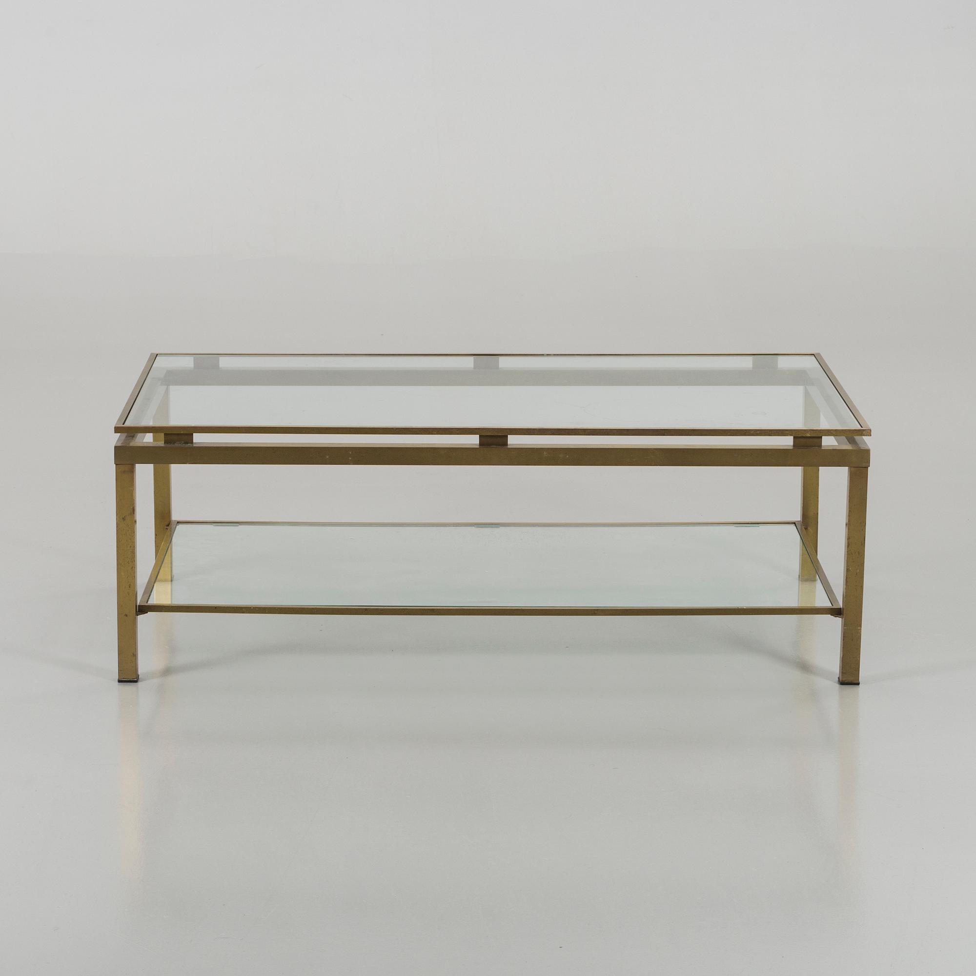 A BRASS GLASS TOP COFFEE TABLE.