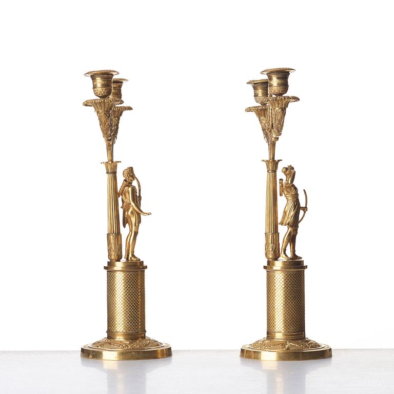 A pair of French Empire two-light gilt bronze candelabra, early 19th century.