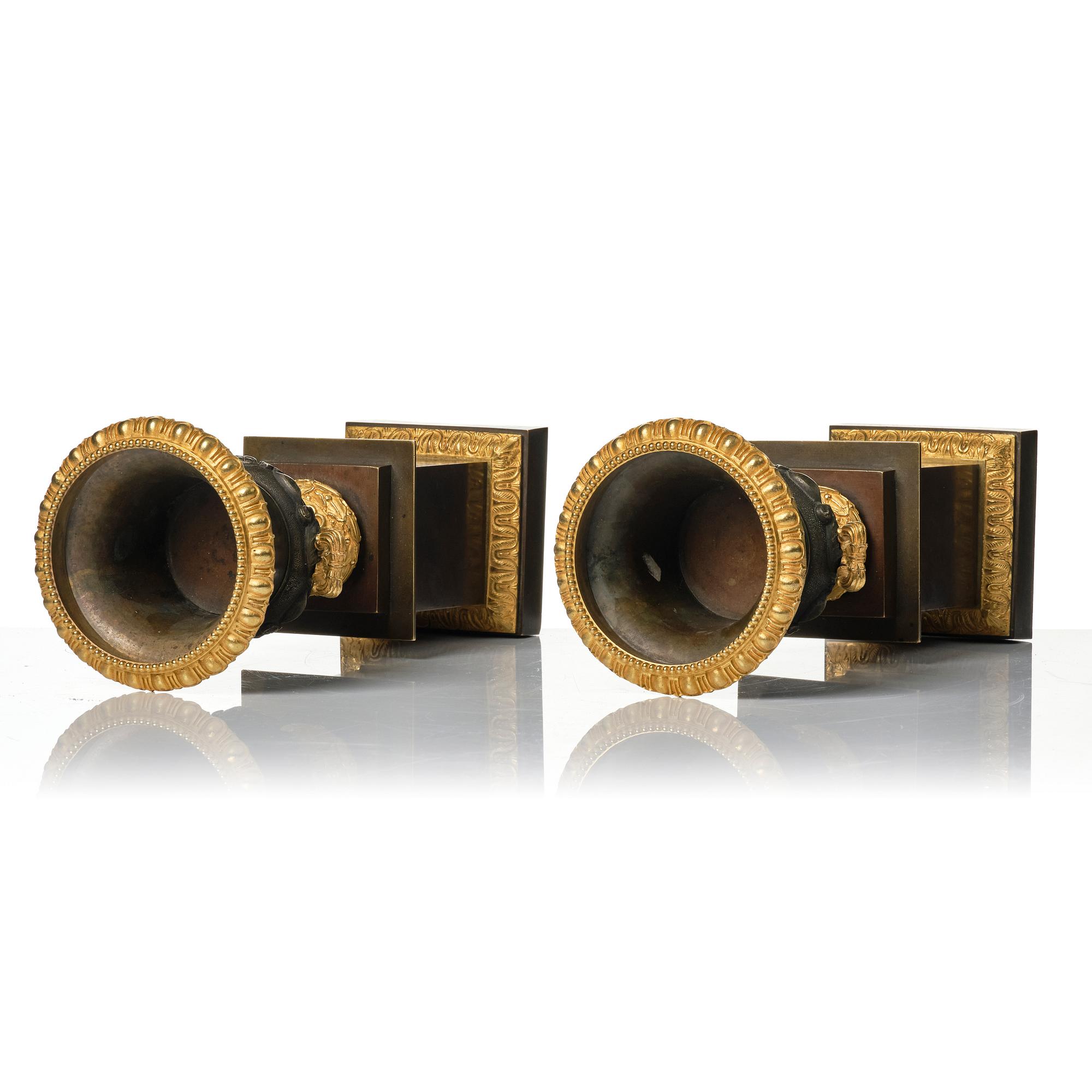 A pair of French Louis Philippe gilt and patinated bronze urns, first part 19th century.