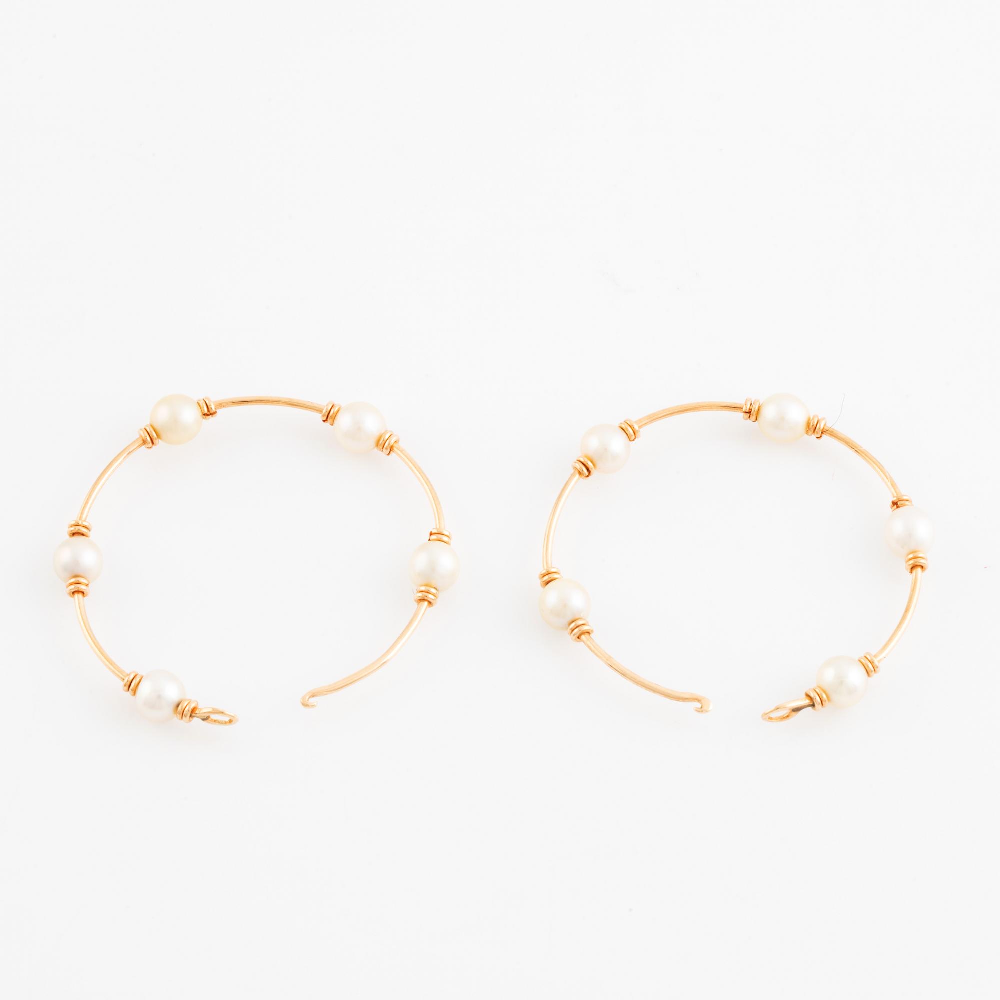 Gold and pearl hoop earrings.