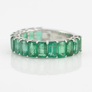 Ring with emerald-cut emeralds.