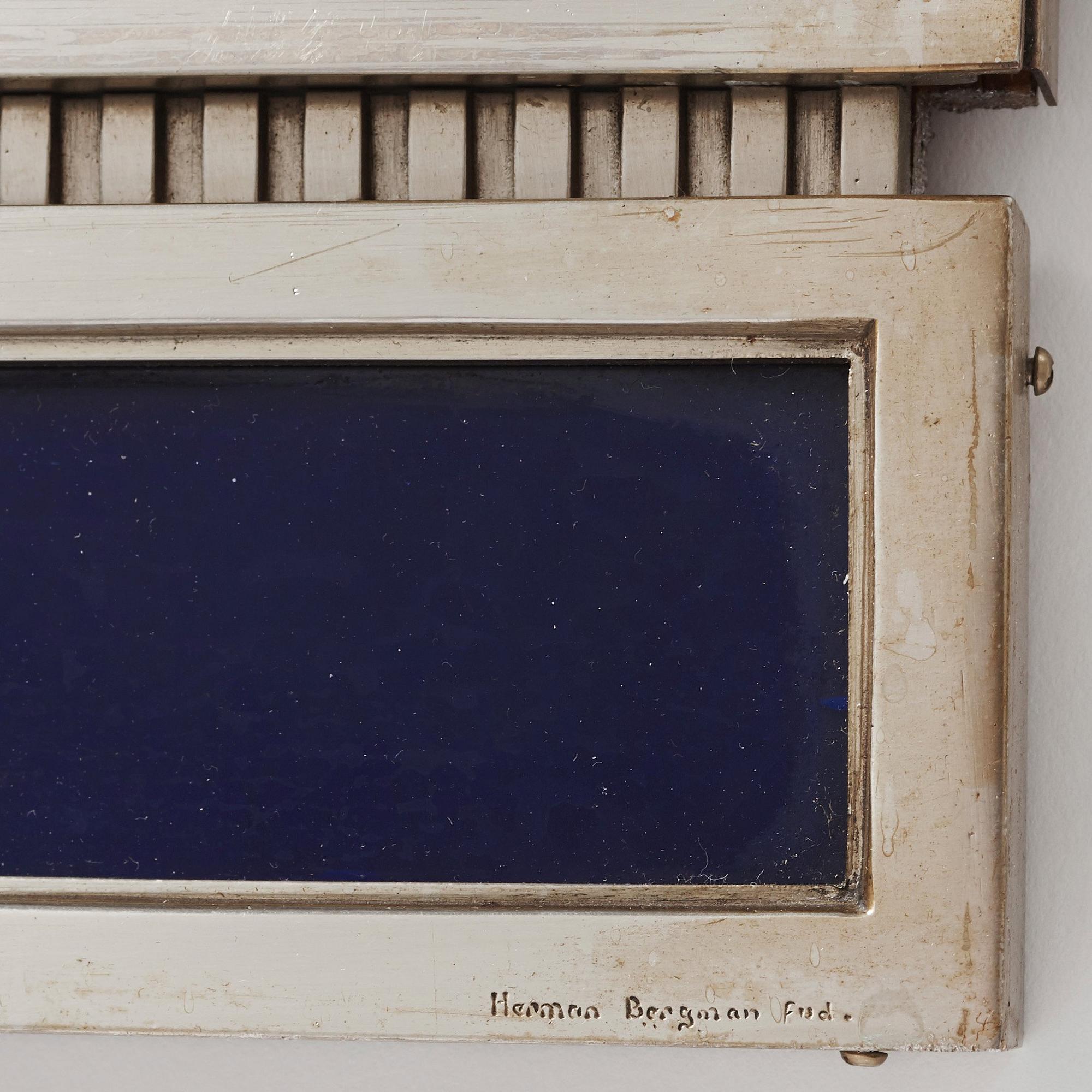 A Swedish Grace white metal framed mirror by Herman Bergman, Stockholm 1920-30's.