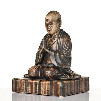 A painted and lacquered wooden sculpture of a monk, Japan, 19th century.