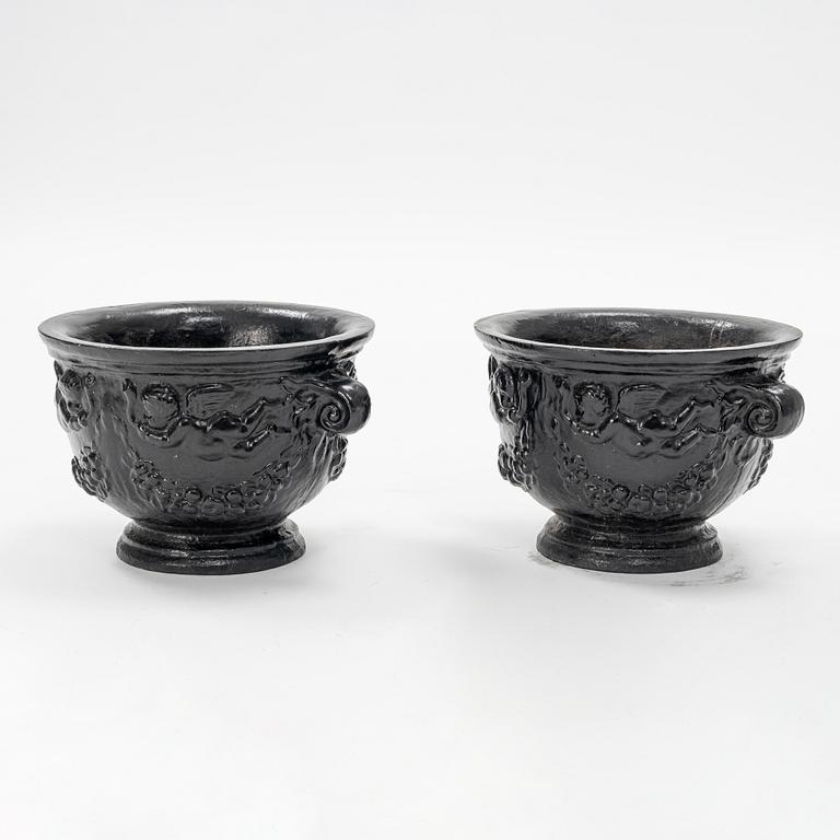 A pair of cast-iron urns.
