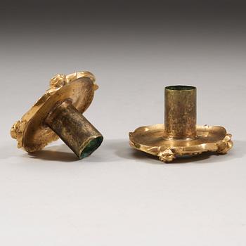 A pair of Louis XV 18th century gilt bronze candlesticks after the model by Juste-Aurèle Meissonnier.