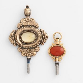 Two pocket watch key winders, gold, citrine and carnelian, 19th century.