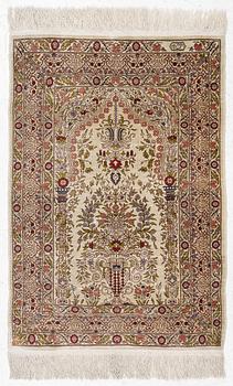 A silk Hereke rug, signed, c. 93 x 64 cm.