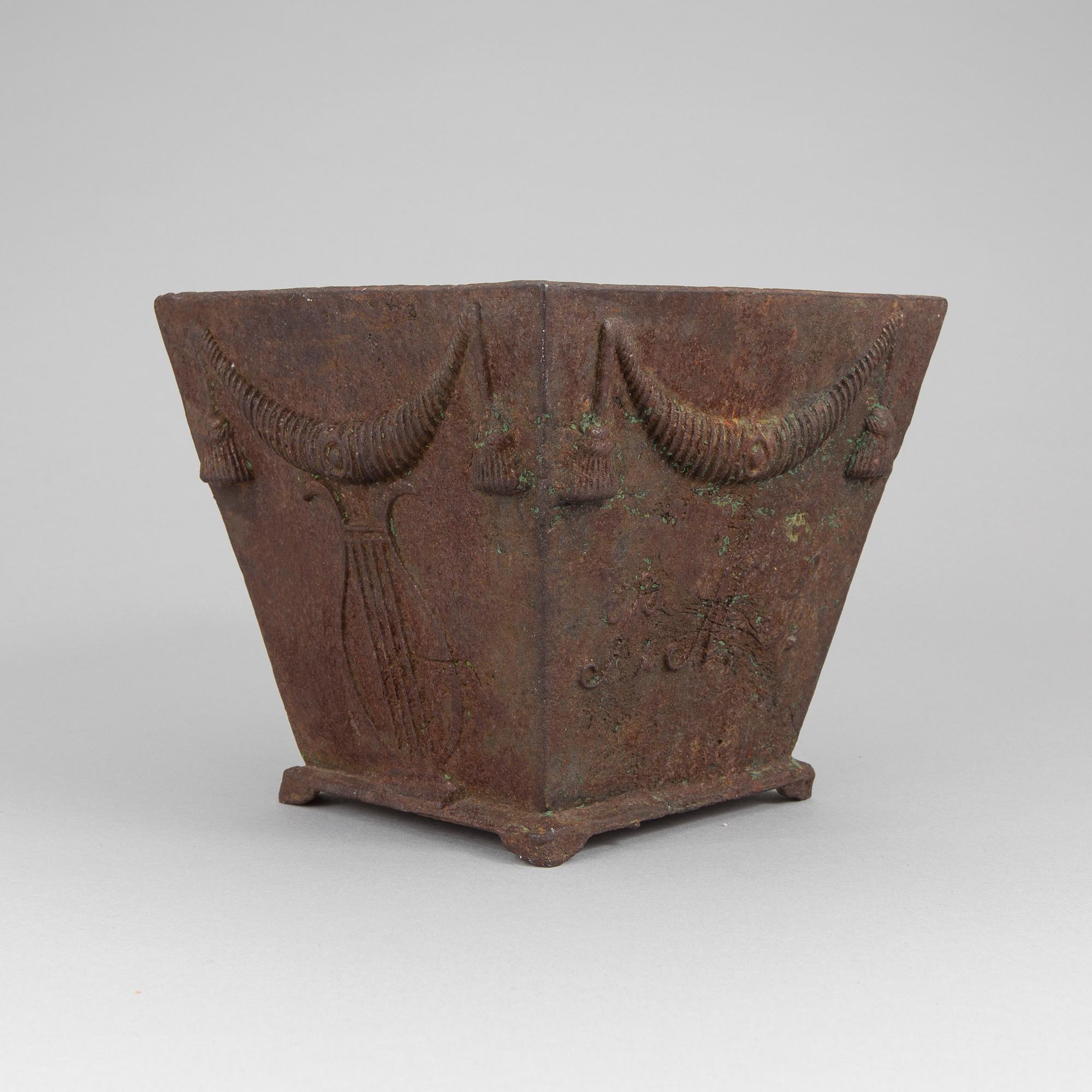An early 19th century flower pot of cast iron.