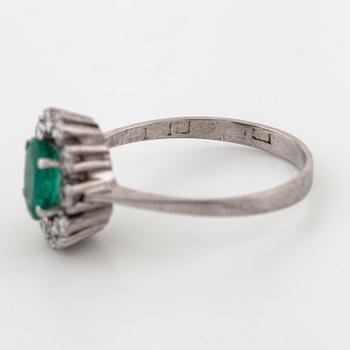 A emerald and brilliant cut diamond ring.