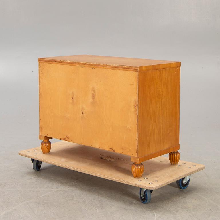 A 1940s elm chest of drawers.