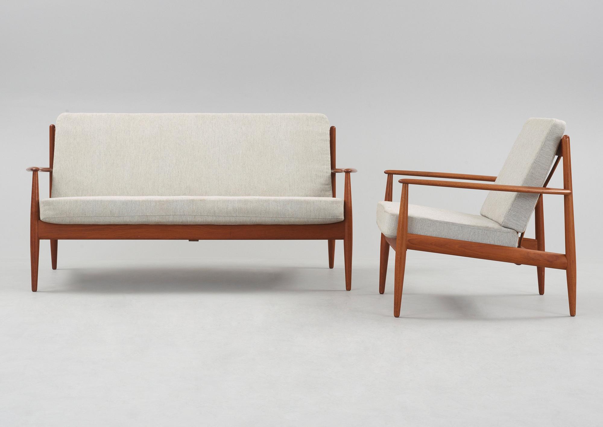 A Grete Jalk teak sofa and armchair, cusions upholstered in grey fabric, France & Daverkosen, Denmark 1960's.