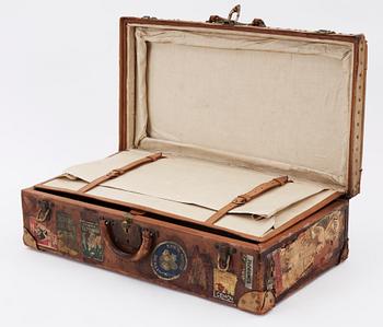 A late 19th cent leather suitcase by Louis Vuitton.