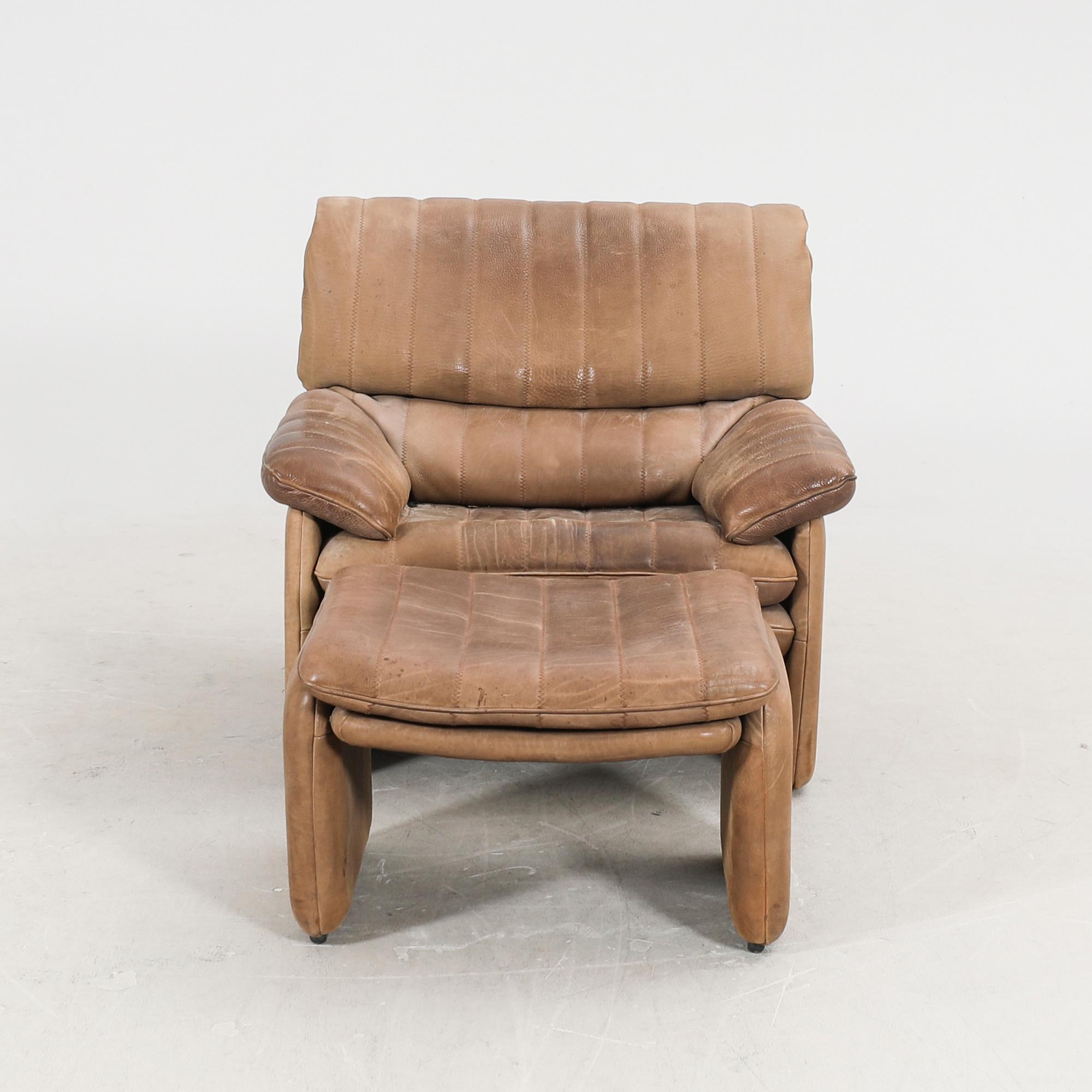 A leather armchair and fotstool by De Sede, Schweiz second half of the 20th century.