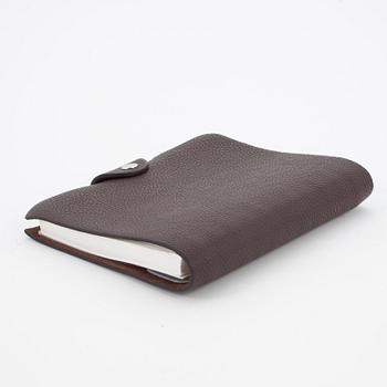 HERMÈS, a brown leather notebook, "Ulysse Petit Modèle".