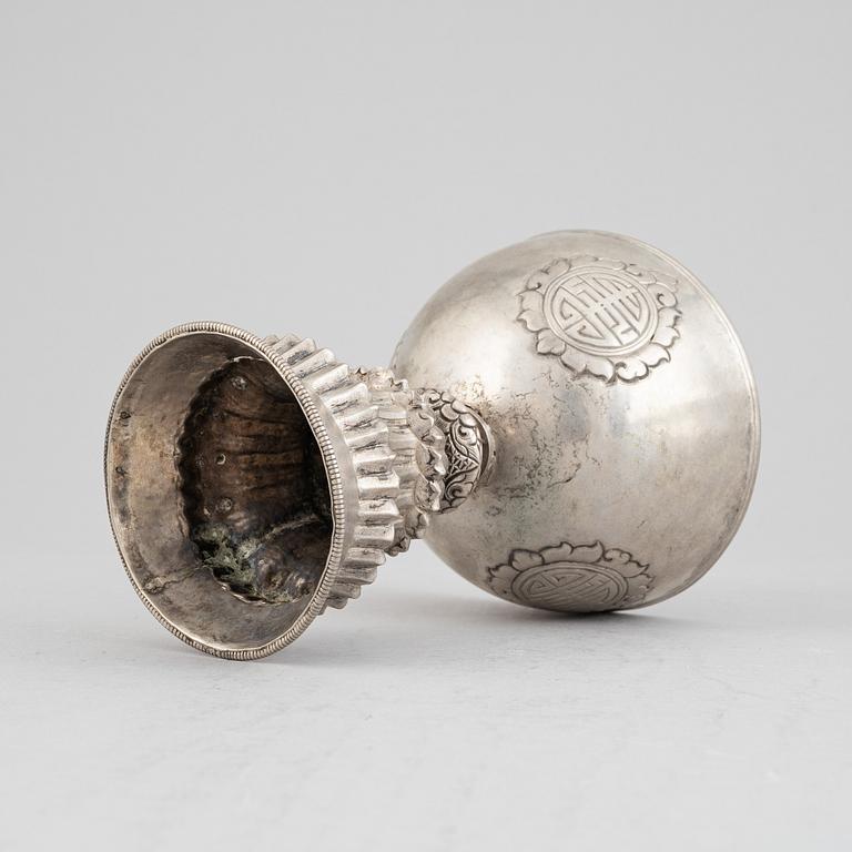 A Tibetan butter lamp, silvered copper, 20th century.