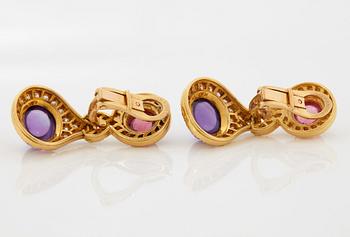 A pair of 18K gold Bulgari earrings set with cabochon-cut amethyst and tourmaline.