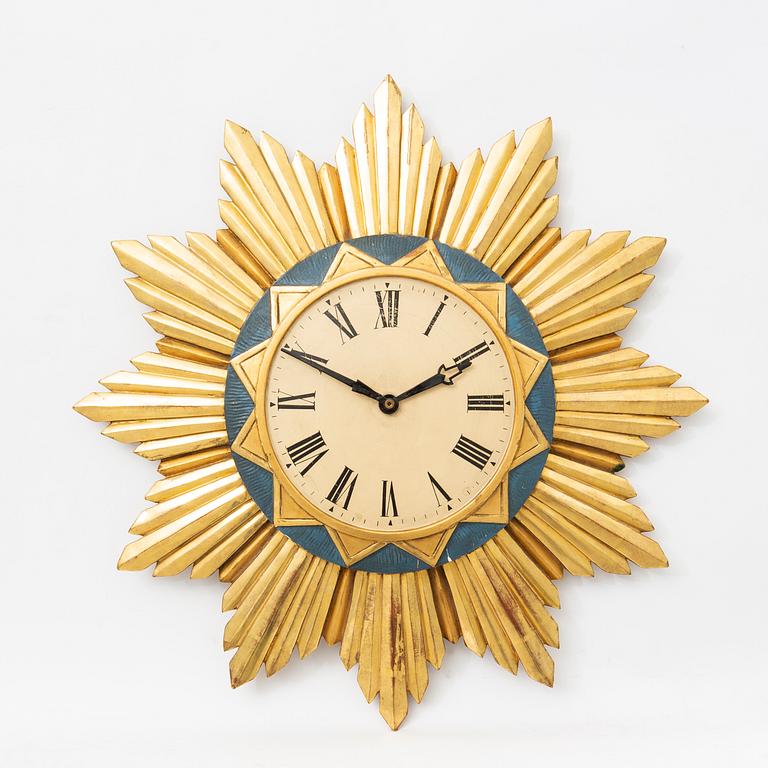 A mid 1900s gilded wall clock.