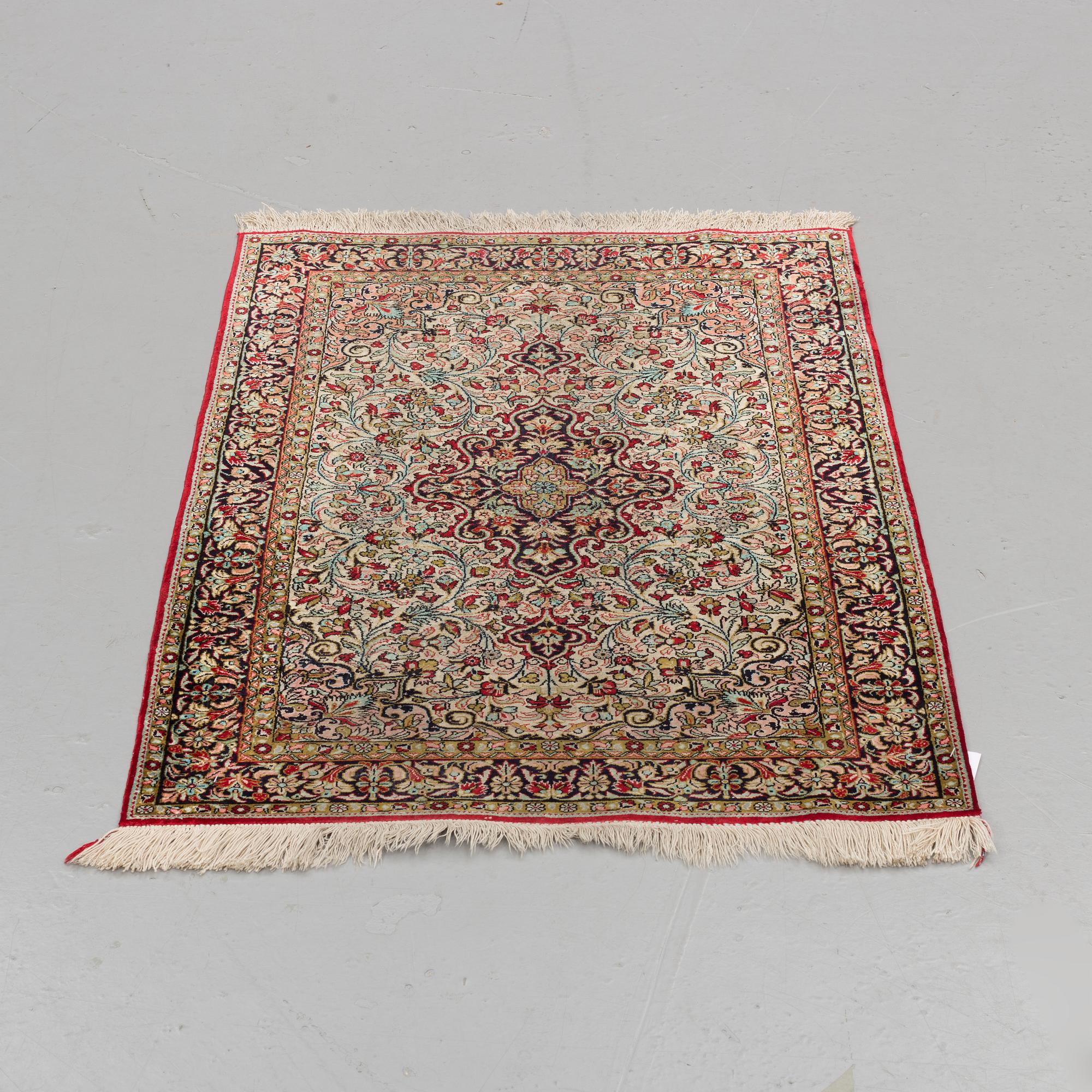 A silk Qum rug, around 114 x 80 cm.