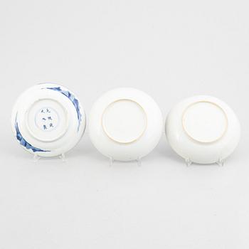 Three small porcelain plates and a cup with saucer, China, 18th century, and an English 19th century cup with saucer.