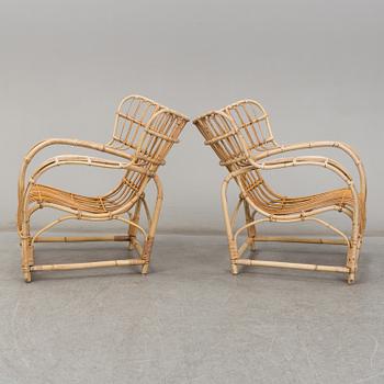 A pair of mid 20th century rattan easy chairs.