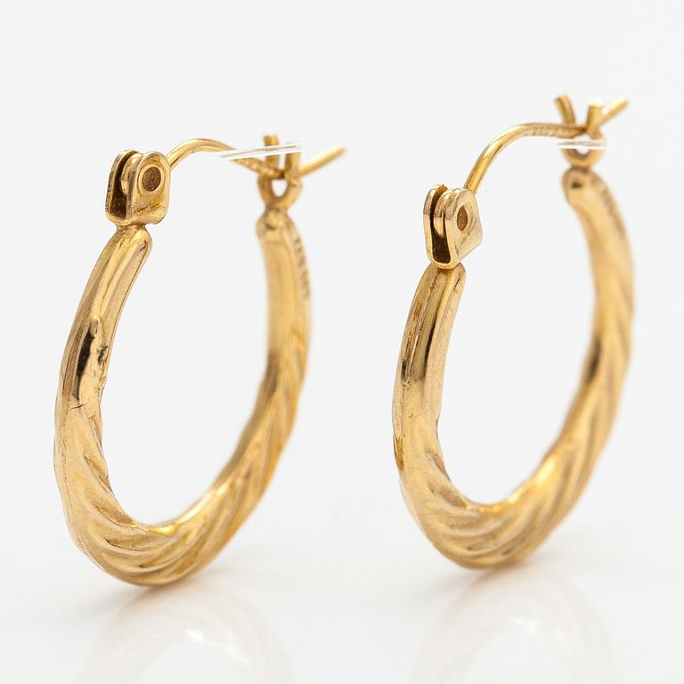 A pair of 14K gold earrings.