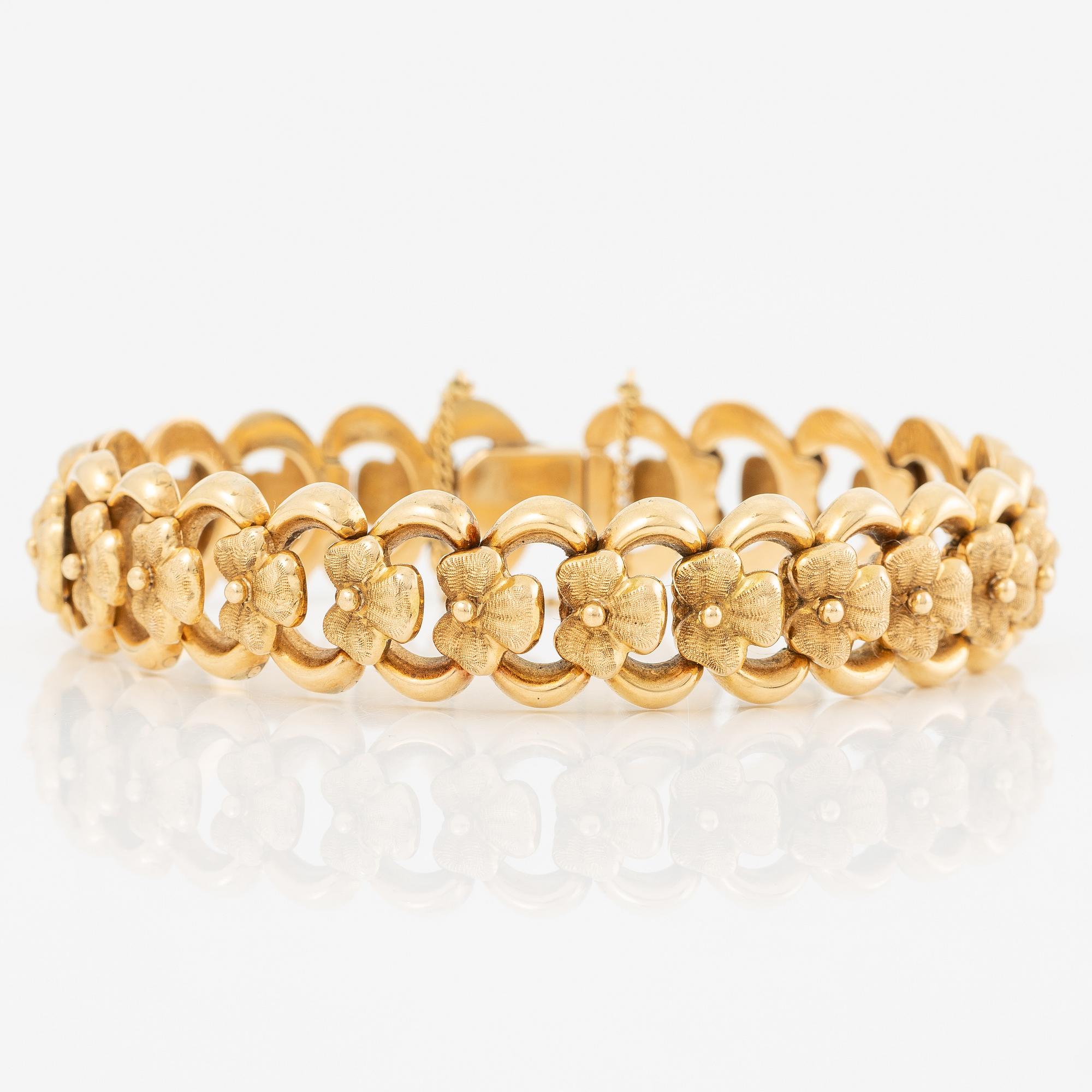 Arm bracelet, 18K gold, decoration of flowers.