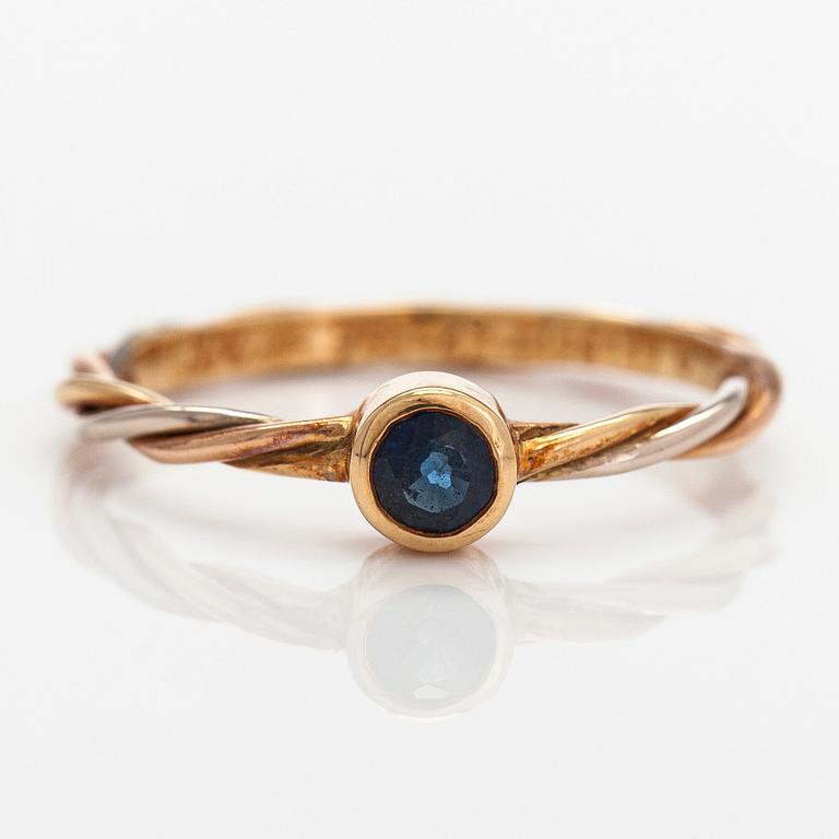 Cartier, an 18K tri-colour gold ring with a sapphire.