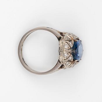 A circa 9.95 ct Ceylon sapphire surrounded by old-cut diamonds, total carat weight circa 0.40 ct.
