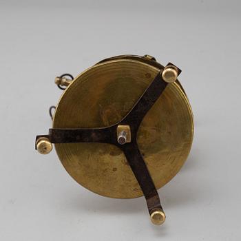 A brass candleholder with wax candle. 19th century.