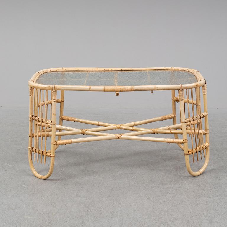 A rattan and glass table and a rattan sofa, second half of the 20th century.