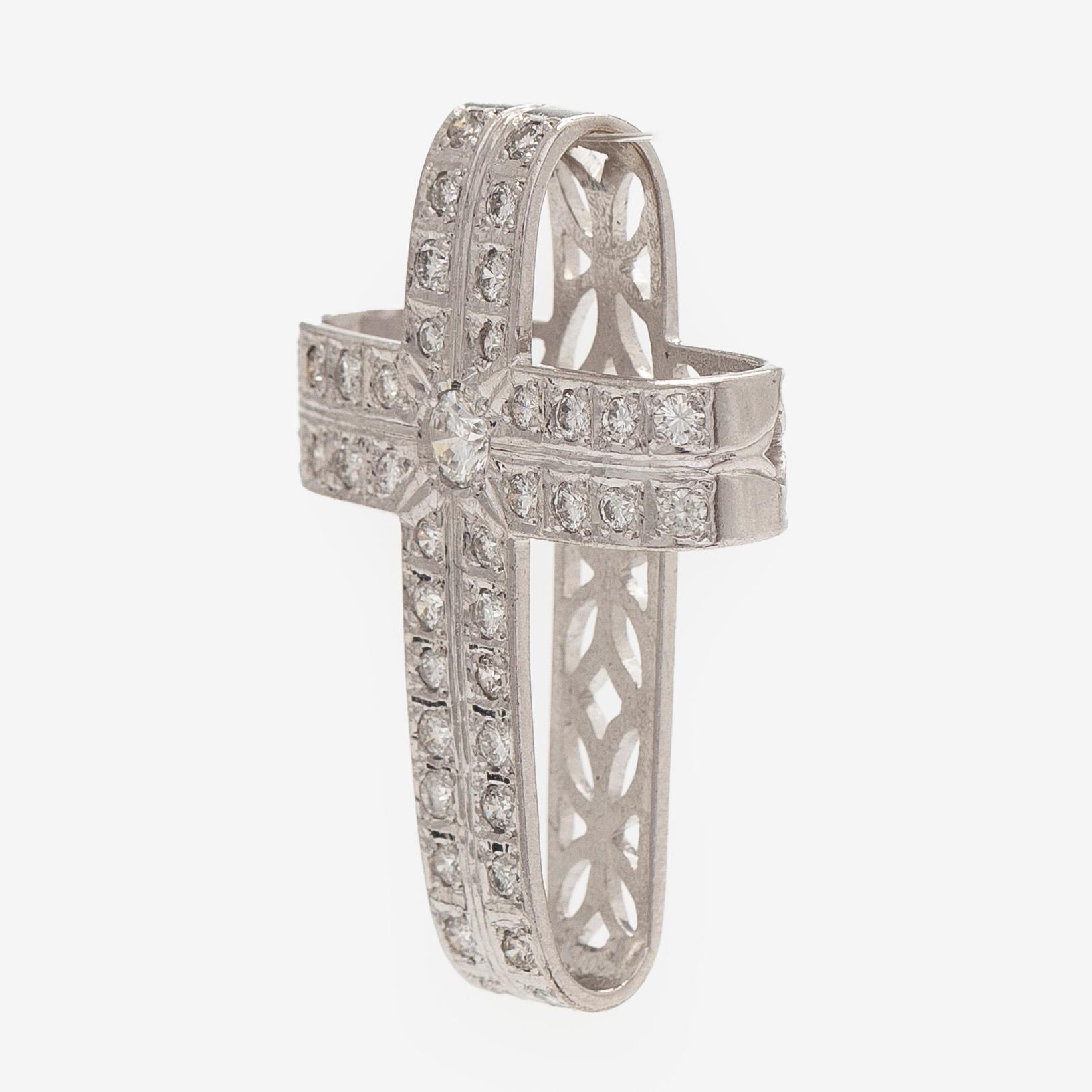 An 18K white gold cross pendant with diamonds.