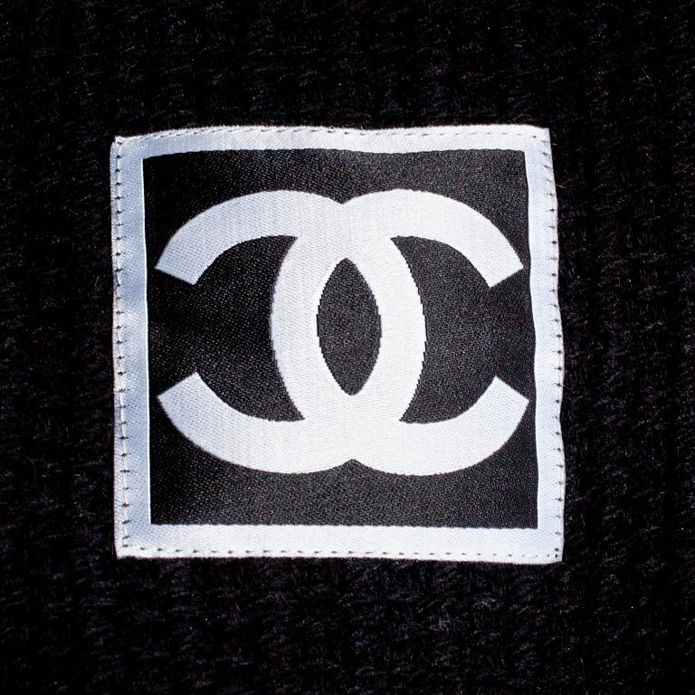 CHANEL, a black cashmere carding and a bouclé skirt.