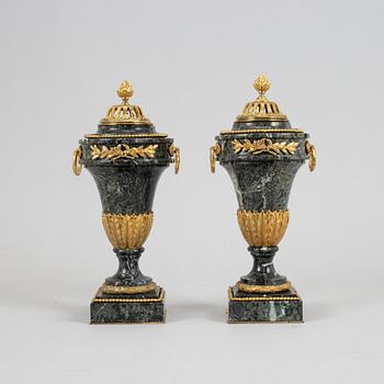 A pair of marble and gilt bronze decorative urns, Louis XVI-style, late 19th Century.