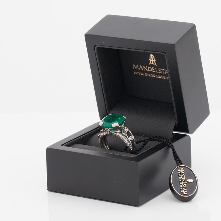 An octagonal cut 6.50 ct emerald and brilliant cut diamond ring. Mandelstam 'Ice Age'.
