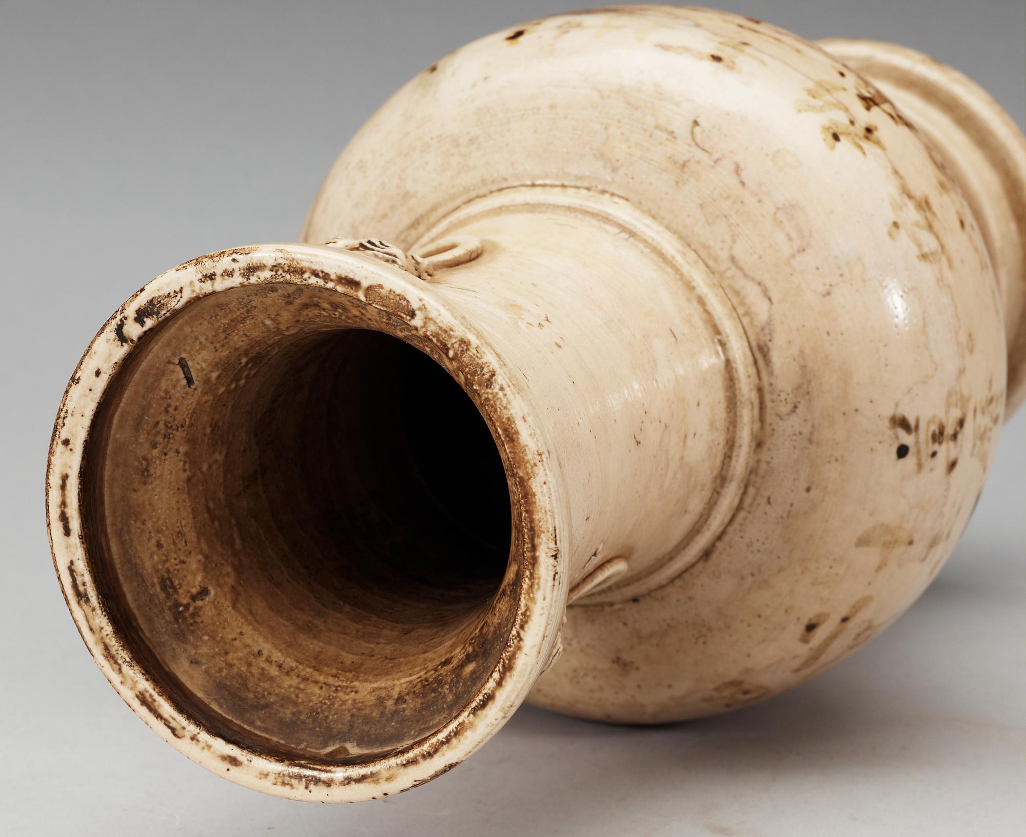 A cream glazed vase, Ming dynasty, with an inscription that dates it to 1608.