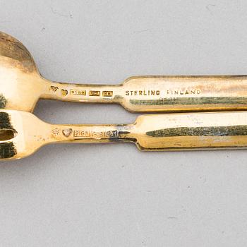 A 12-piece set of 1950s two-tine forks and espresso spoons in gilt silver and enamel, Tillander, Helsinki 1951-55.