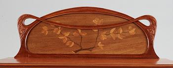 An Art Nouveau mahogany cabinet with inlays and carved decoration, possibly France or Belgium, circa 1900.