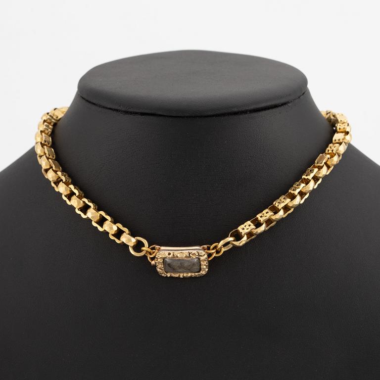 Necklace with a hair compartment, gilded silver.