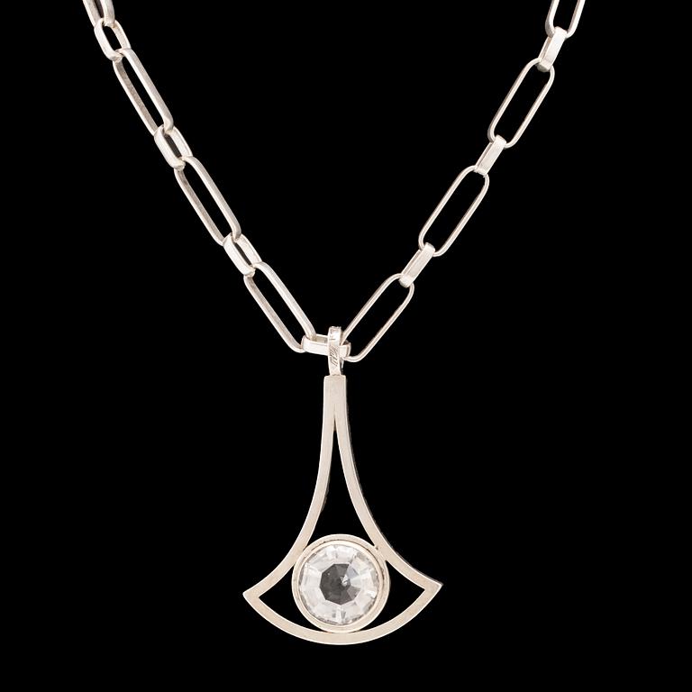 A silver necklace set with a round faceted rock quartz crystal by Göran Kuhlin Gothenburg 1971.