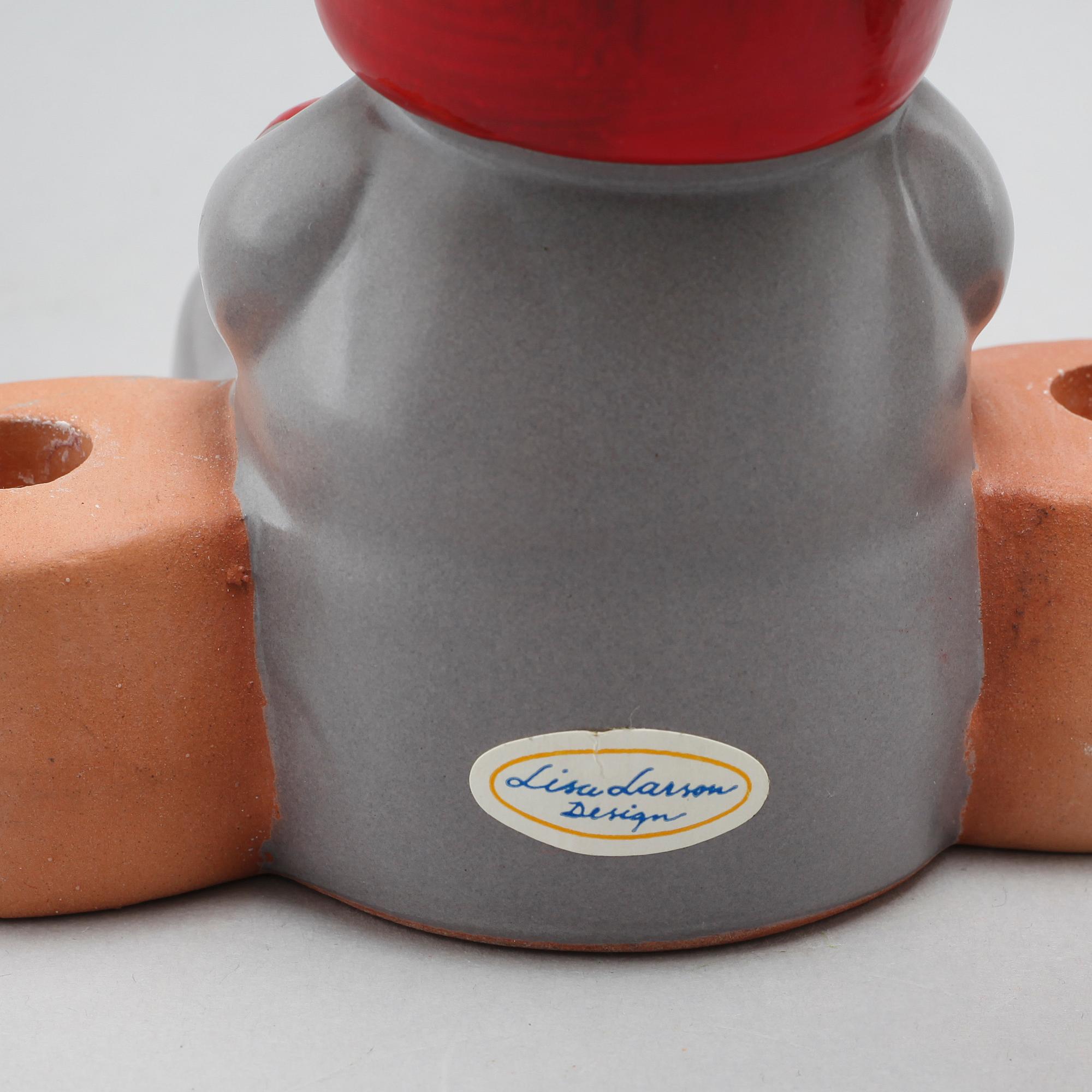 Three ceramic candlesticks by Lisa Larson for Gustavsberg, partly signed.