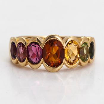 An 18K gold ring, with multi-coloured stones.