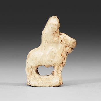 A cream-glazed miniature pottery equestrian, Song- (960-1279)/ Yuan dynasty (1271-1368).